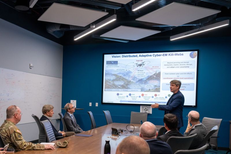 An ICE-CEM research presentation to visitors in a Duke conference room